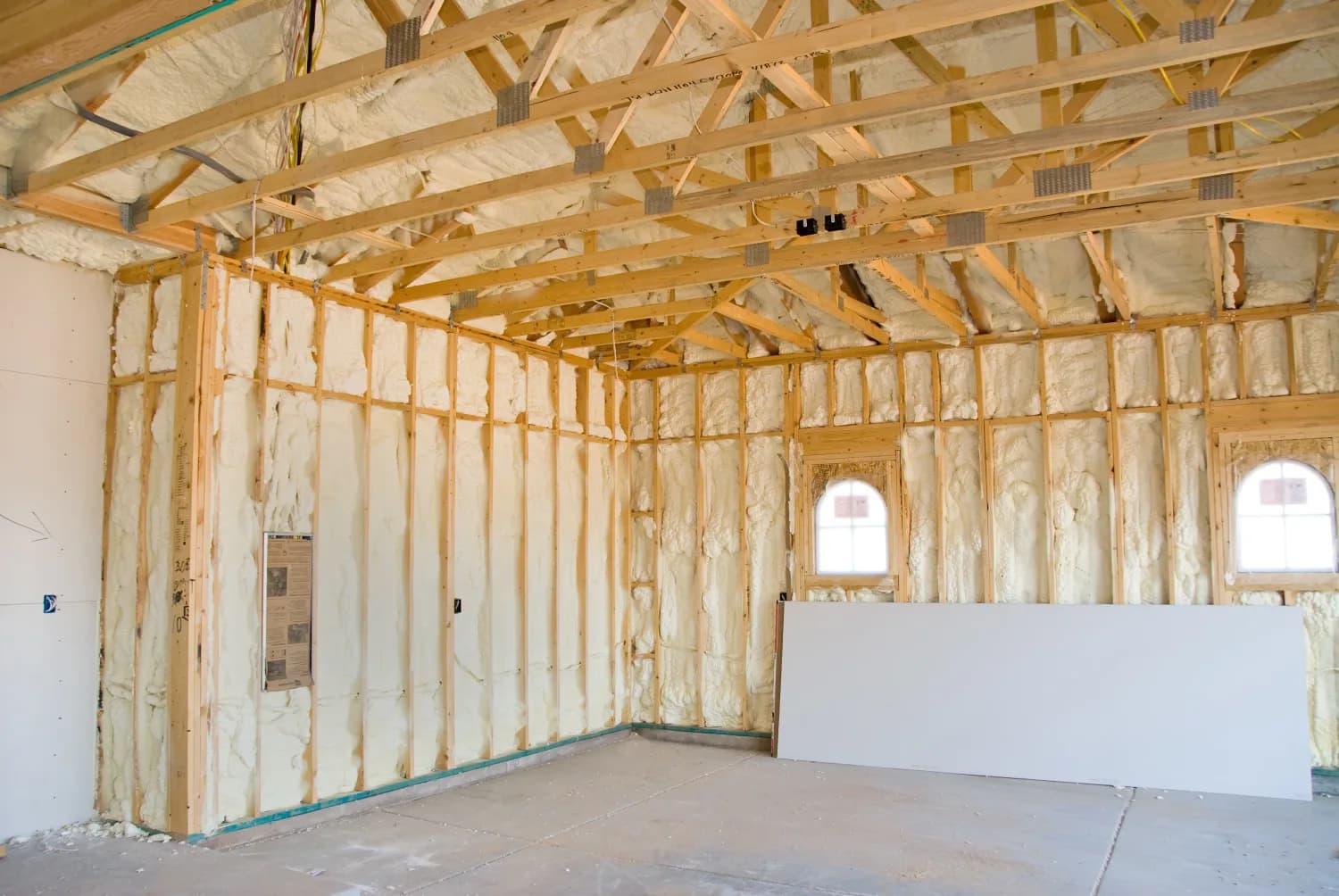 Newly insulated room with exposed framing during a renovation