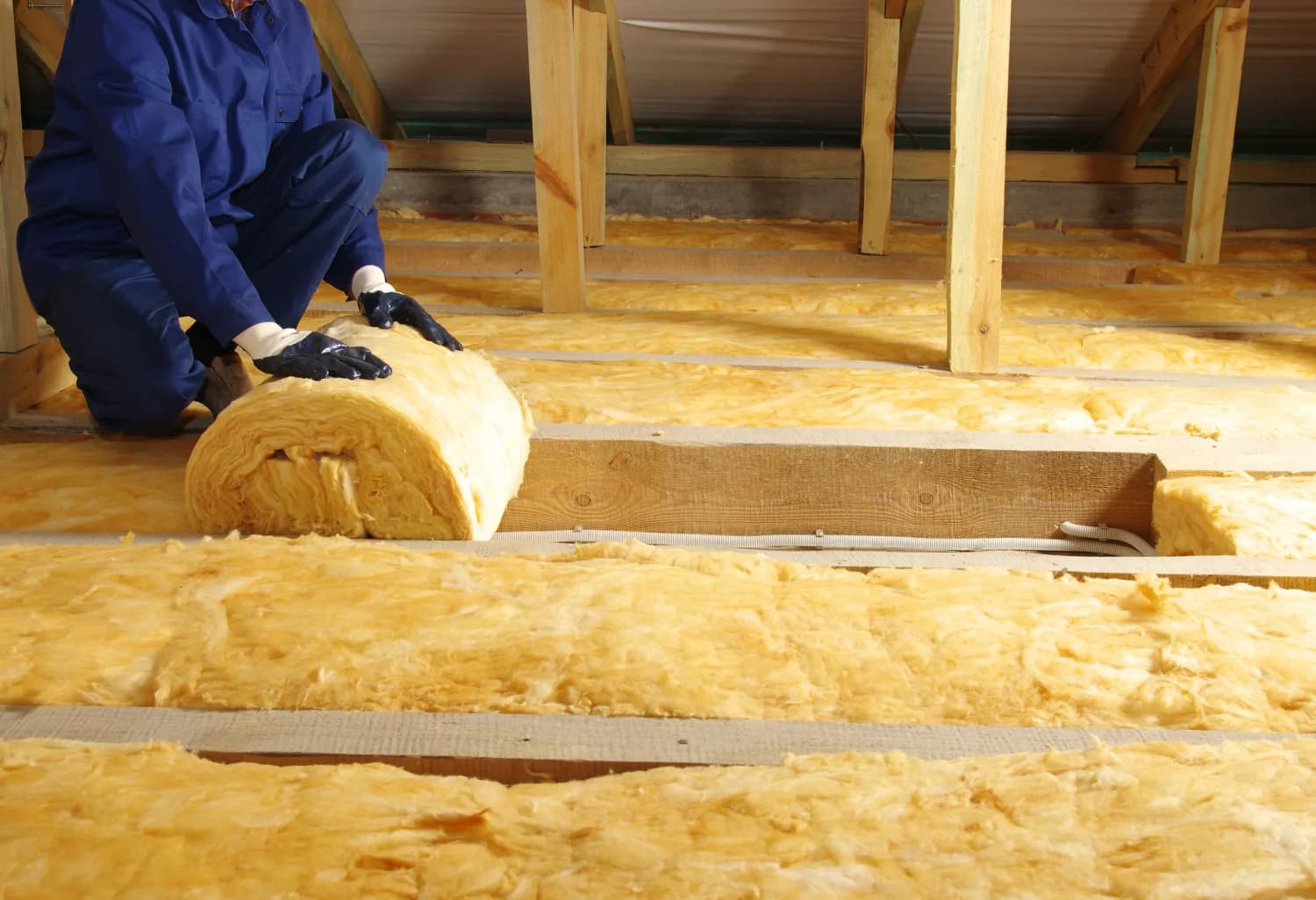 Mineral wool roll laid between floor joists for sound dampening